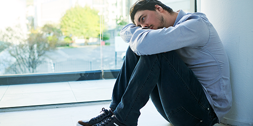 Image of man staring out the window, image linked used for the Schizophrenia E&A page